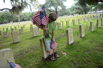 Tyler Carpenter, 9, a 4th grader at Riverview Charter School, places an American flag on one of the graves at the Beaufort National Cemetery on Thursday, May 26, 2016, in Beaufort. This is the second year that the 4th and 5th graders at Riverview Charter School have come out to place flags on the graves at the Beaufort National Cemetery before Memorial Day. Local schools community service groups and private families come out every year to place the flags. "If someone wants to help out with before Memorial Day, we will always be able to find something for them to do," Patricia Simmons, program assistant with the Beaufort National Cemetery said. "The number of people who want to help has grown every year." To find out more information about how you can volunteer your time at the Beaufort National Cemetery call Patricia Simmons at 843-524-3925.